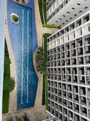 an overhead view of a building with a swimming pool at The Ren Suite Facing Amenities in Manila