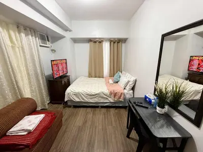a living room with two beds and a couch at LA VERTI 1B MINIMALIST AFFORDABLE STAYCATION IN PASAy in Manila