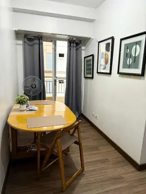 a dining room with a table and a window at LA VERTI 1B MINIMALIST AFFORDABLE STAYCATION IN PASAy in Manila