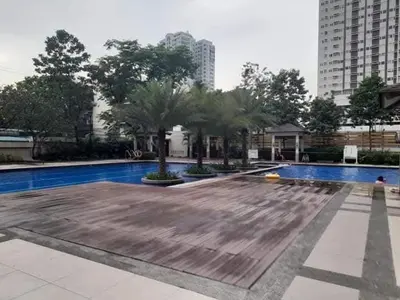a large swimming pool with trees and buildings at LA VERTI 1B MINIMALIST AFFORDABLE STAYCATION IN PASAy in Manila