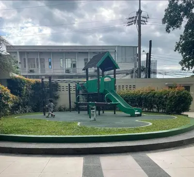 a playground with a green slide in a park at LaVerti 1BR Affordable staycation groups family in Manila