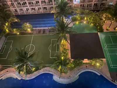 an overhead view of a swimming pool with a basketball court at Scarlet Stay in Manila