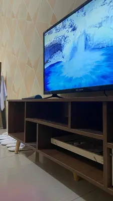 a flat screen tv sitting on top of a entertainment center at Scarlet Stay in Manila