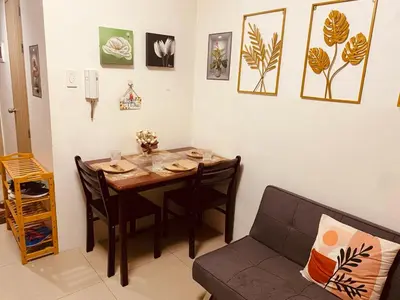 a living room with a table and a couch at Scarlet Stay in Manila