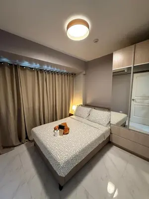 a bedroom with a bed with a bag on it at Bayhaus MNL - Pet-friendly Condo near MOA in Manila