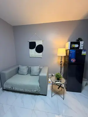 a living room with a couch and a table at Bayhaus MNL - Pet-friendly Condo near MOA in Manila