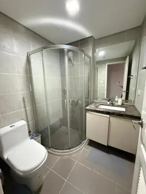 a bathroom with a shower and a toilet and a sink at Bayhaus MNL - Pet-friendly Condo near MOA in Manila