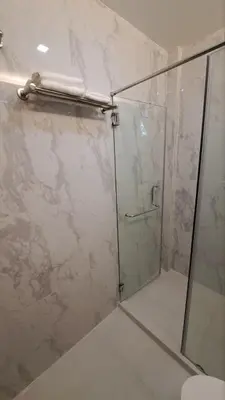 a bathroom with a shower with a glass door at Brand New Home! 3BR, 5 Beds, 3 Baths, Full AC in San Agustin