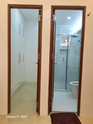 a bathroom with a glass shower and a toilet at Brand New Home! 3BR, 5 Beds, 3 Baths, Full AC in San Agustin
