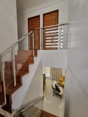 a staircase in a house with a glass railing at Brand New Home! 3BR, 5 Beds, 3 Baths, Full AC in San Agustin