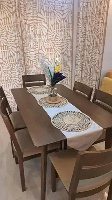 a dining room table with chairs and a tablecloth on it at Brand New Home! 3BR, 5 Beds, 3 Baths, Full AC in San Agustin