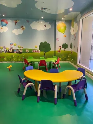 a classroom with tables and chairs and clouds on the wall at BayHaus MNL - Pet-friendly Condo Near MOA in Manila