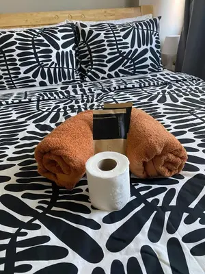 a bed with a roll of toilet paper on it at BayHaus MNL - Pet-friendly Condo Near MOA in Manila