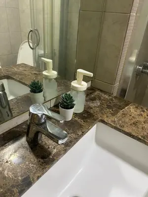 a bathroom counter with a sink and a mirror at BayHaus MNL - Pet-friendly Condo Near MOA in Manila