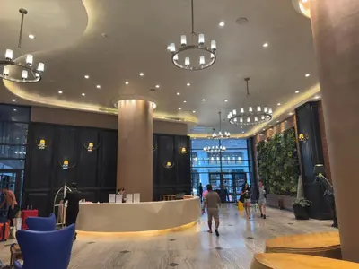 a lobby with people walking around in a building at Place in Century Poblacion in Manila