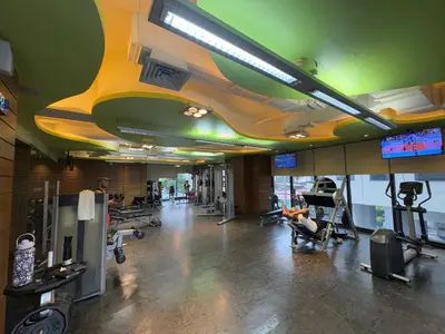 a gym with people exercising on machines in a gym at Place in Century Poblacion in Manila