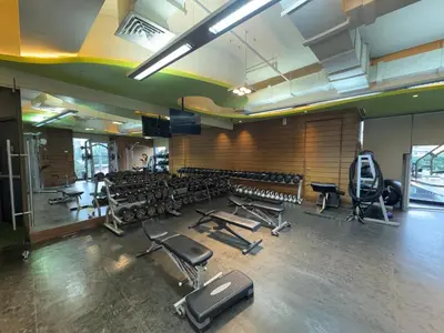 a gym with several rows of exercise bikes and weights at Place in Century Poblacion in Manila