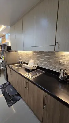 a kitchen with a sink and a counter top at Sevillano's City Escape at Shore 1 Near MOA in Manila