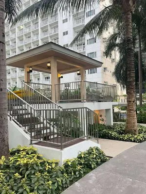 a building with a staircase in front of a building at Sevillano's City Escape at Shore 1 Near MOA in Manila