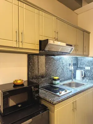a kitchen with a sink and a microwave at BBricks Alabang Beside Festival Mall in Manila