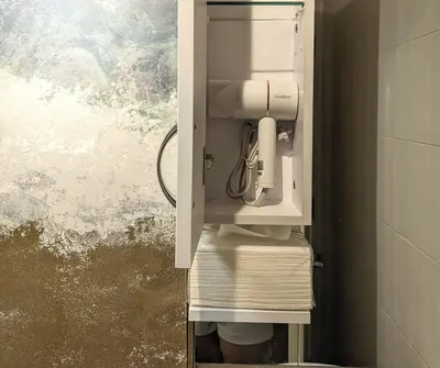 a white mixer in a cabinet in a bathroom at BBricks Alabang Beside Festival Mall in Manila