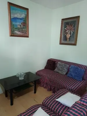 a living room with two couches and a table at One Oasis Ortigas H212 in Manila
