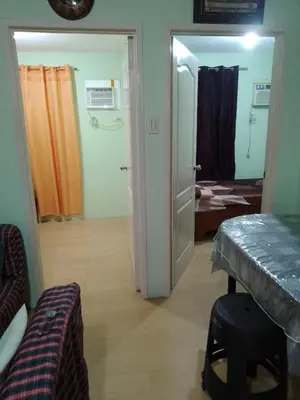 a room with a door open to a room with a bedroom at One Oasis Ortigas H212 in Manila