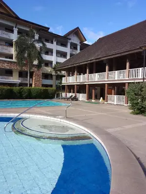 an empty swimming pool in front of a building at One Oasis Ortigas H212 in Manila