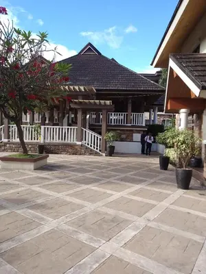 a courtyard of a house with trees and a building at One Oasis Ortigas H212 in Manila