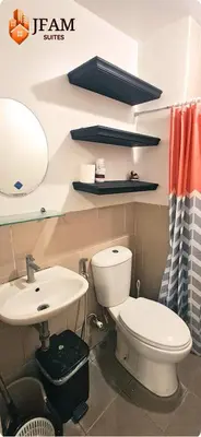a bathroom with a toilet and a sink at JFam Suites, C4-10U Studio, Up To 4 Pax in Biñan