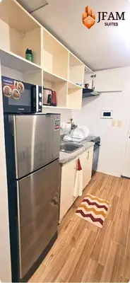 a kitchen with a stainless steel refrigerator and a wooden floor at JFam Suites, C4-10U Studio, Up To 4 Pax in Biñan