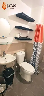 a bathroom with a toilet and a sink at JFam Suites, C4-10U Studio, Up To 4 Pax in Biñan