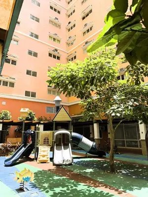 a playground in front of a building with a slide at JFam Suites, C4-10U Studio, Up To 4 Pax in Biñan