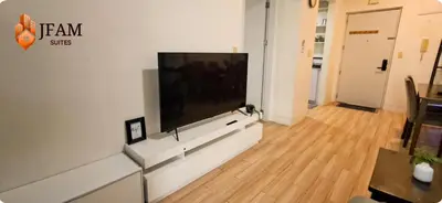 a living room with a large flat screen tv on a wall at JFam Suites, C4-10U Studio, Up To 4 Pax in Biñan