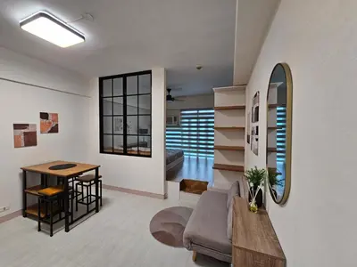 a living room with a couch and a table at Affordable Condo Suite with WIFI in McKinley BGC in Manila