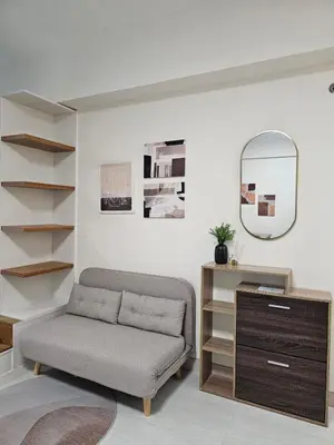 a living room with a bench and a mirror at Affordable Condo Suite with WIFI in McKinley BGC in Manila