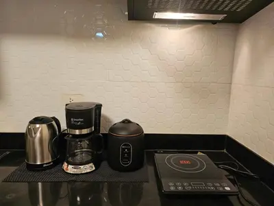 a counter top with a coffee maker and a coffeemaker at Affordable Condo Suite with WIFI in McKinley BGC in Manila
