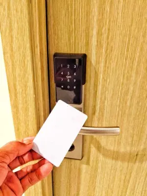 a person holding a piece of paper in front of a door at DS Staycation in Manila