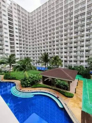 a large apartment building with a large swimming pool at DS Staycation in Manila