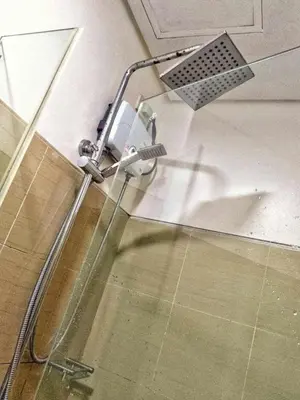 a shower in a bathroom with a shower head at DS Staycation in Manila