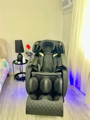 a black car seat in a room with a bed at Nuvali - Free use of Massage Chair-Pool Access-Hot Shower in Calamba