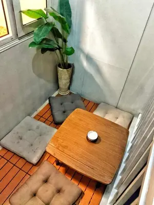 a small room with a table and chairs and a plant at DS Staycation in Manila