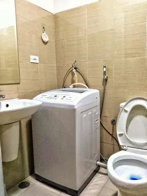 a small bathroom with a toilet and a sink at DS Staycation in Manila