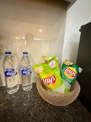 a refrigerator with two bottles of water and snacks at Modern Condo at The Venice Luxury Mckinley Hill in Manila