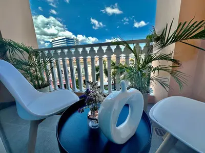 a balcony with a table and chairs on a balcony at Modern Condo at The Venice Luxury Mckinley Hill in Manila
