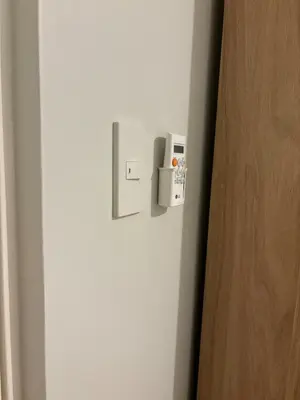 a white refrigerator with a lock on the door at Modern 2BR Condo with Balcony in Central Manila in Manila