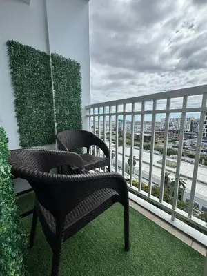 two chairs on a balcony with a view of the ocean at Balay Maria at Shore in Manila