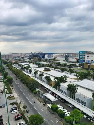 an aerial view of a city with a road and buildings at Balay Maria at Shore in Manila