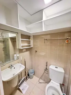 a bathroom with a toilet and a sink at Shore Staycation in Manila