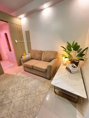 a living room with a couch and a table at Shore Staycation in Manila